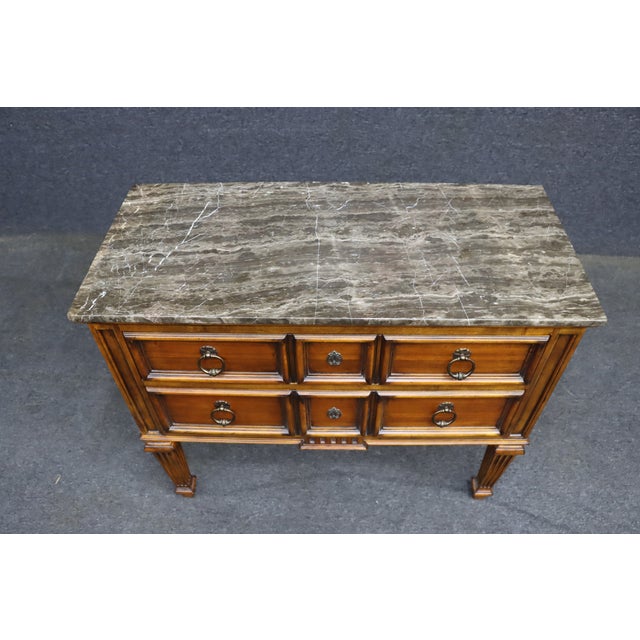 Ethan Allen Louis XVI-style chest of drawers with a substantial gray marble top. The case features six drawers with raised...