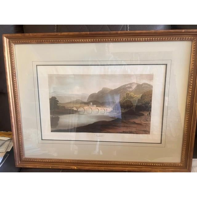 This piece is a vintage lithograph depicting the Scottish landscape of Dunkeld, originating from the 1830-1833 collection,...