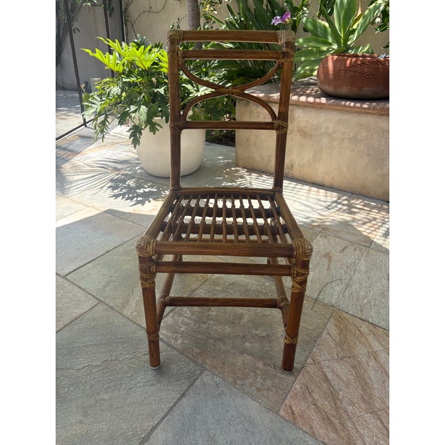 Wonderful pair of exquisite McGuire bamboo and rattan side chairs. Perfect for small spaces, or for an elegant downsizing....
