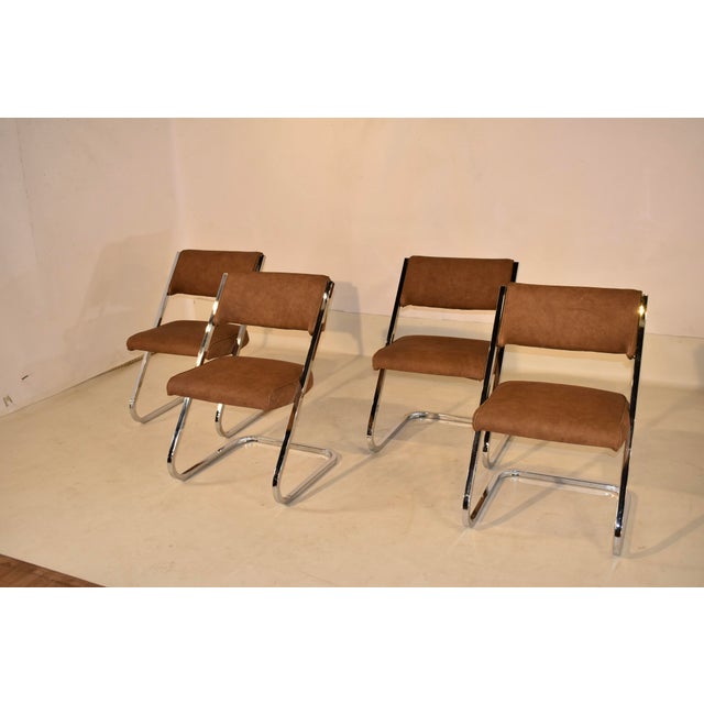 Set of four cantilever chrome chairs by Howell Manufacturing, a division of Burd Inc. This set of chairs have the original...