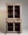 A traditional oak vitrine featuring glazed upper doors for display and a solid lower section for storage. Late 19th...