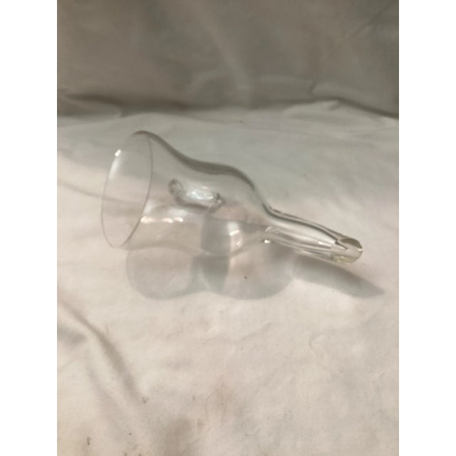 A clear hand blown glass wine funnel with an angled spout and applied side handle. The long, narrow neck directs wine...