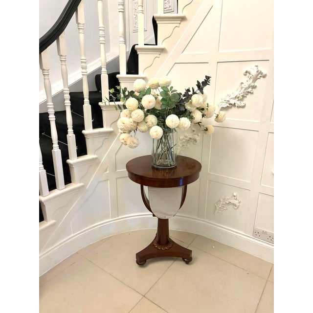 An elegant Victorian circular sewing / lamp table in richly figured mahogany. The circular top is supported on a refined...
