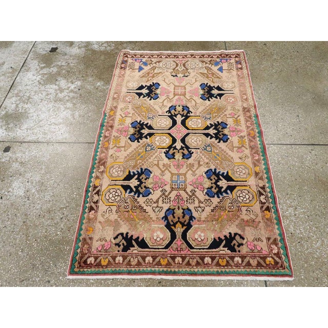 This mid-20th century Turkish Anatolian rug, measuring 3' 0" x 4' 11", showcases a dynamic geometric medallion design with...