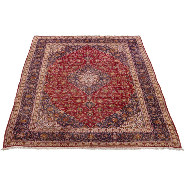 Handmade, vintage Isfahan wool rug in red with a medallion motif and multicolor accents. This rug measures 10' x 14'.