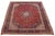 Handmade, vintage Isfahan wool rug in red with a medallion motif and multicolor accents. This rug measures 10' x 14'.