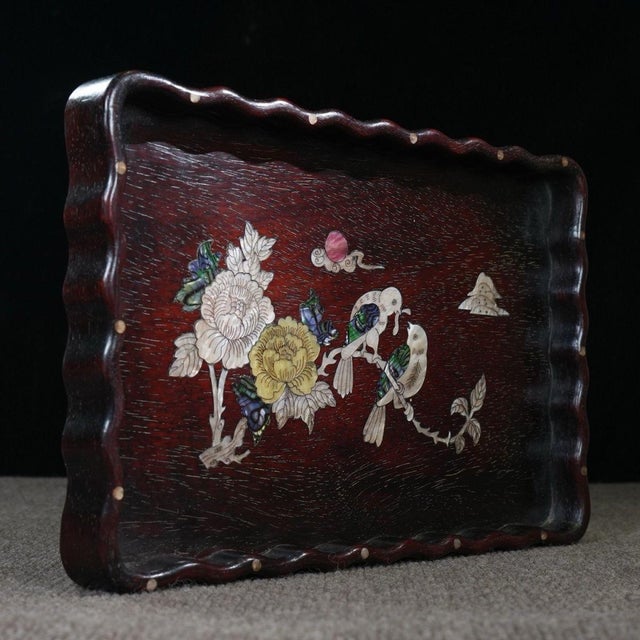 This is a beautifully crafted rectangular wooden tray featuring intricate mother-of-pearl (nacre) inlay and a...