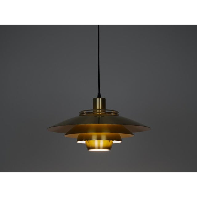 This lamp was designed by Danish designer Kurt Wiborg and manufactured by Jeka. The lamp's form is based on the principle...