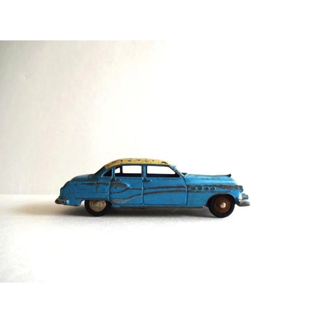 An antique original Dinky Toys miniature scale toy car: model 24V, the Buick Roadmaster. Made in France by Meccano. Blue...