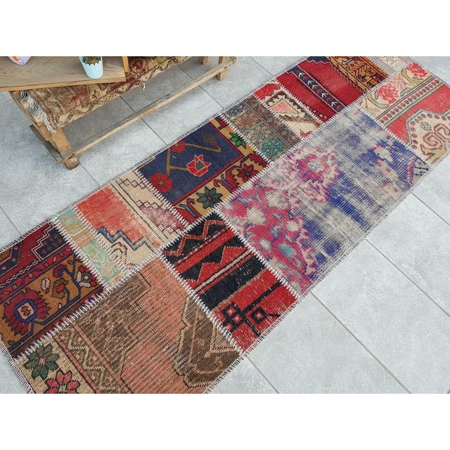 This is a vintage Turkish Oushak rug from the Mid 20th Century. The piece was hand-knotted.