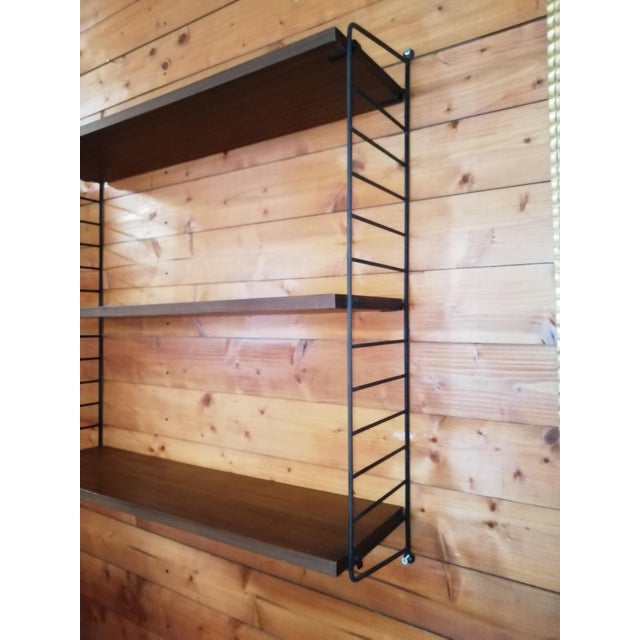 String wall-mounted bookcase by Nils Strinning for String Design AB. Two iron sides and three shelves. Extremely...
