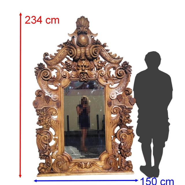 Impressive mirror entirely carved from wood, featuring chimeras, faces, and animal paws amidst a dense floral/vegetal...