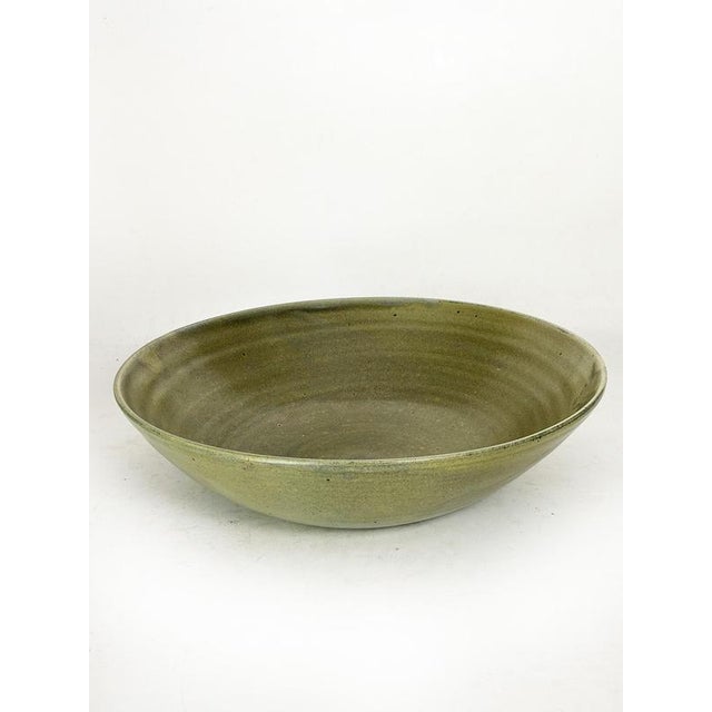 Large glazed ceramic trinket dish or fruit bowl, signed, made in France in the 1940s. This elegant handcrafted piece is...