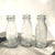 These early 20th-century clear glass battery oil bottles were produced for the Thomas A. Edison Industries storage battery...