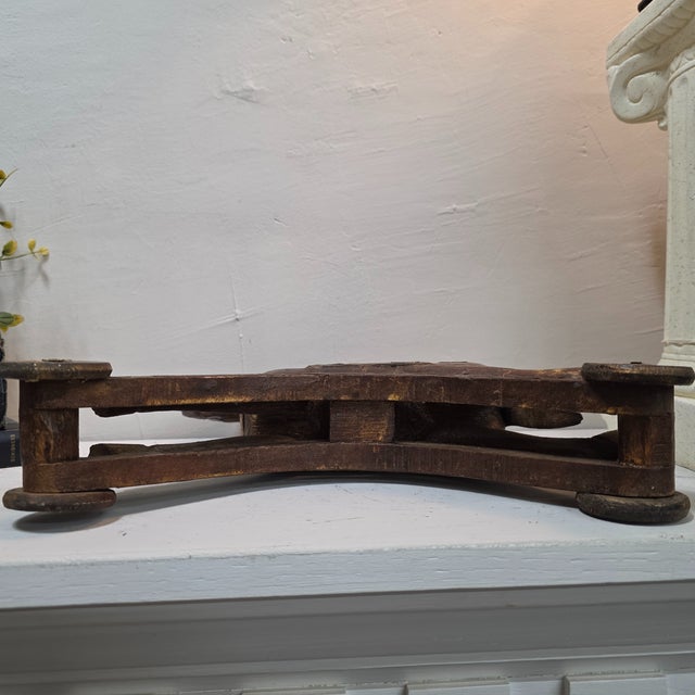 A charming turn-of-the-century European wooden toy horse on wheels, featuring hand-applied brass and copper sheet...