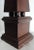 This is a vintage walnut obelisk dotted with worm holes. This tabletop piece features a square base and has four non-...