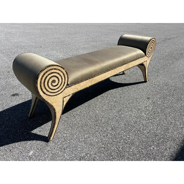 Tessellated stone scroll arm bench with upholstered seat and arms.