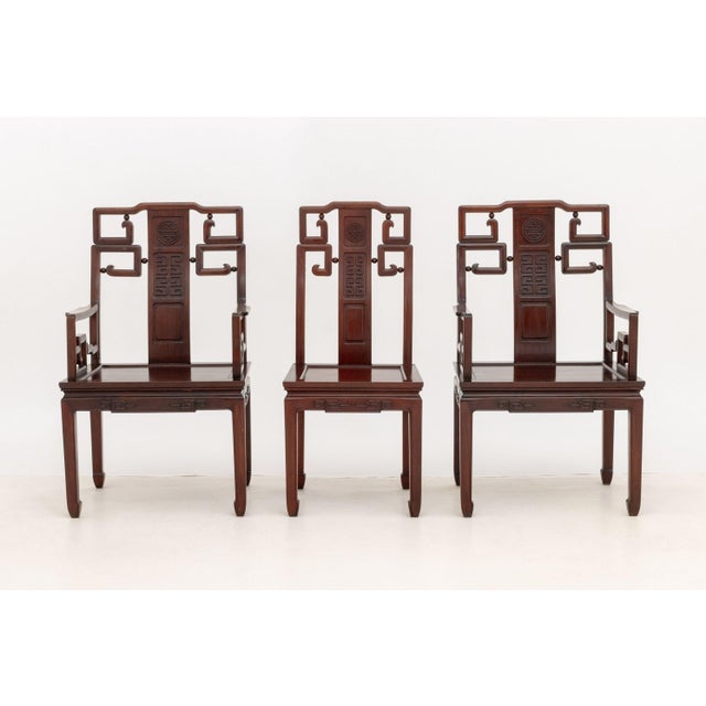 Pair of Chinese Carved Rosewood Armchairs, with one Side Chair. 38" H x 23" W x 22" D; seat 17" H. Provenance: An Upper...