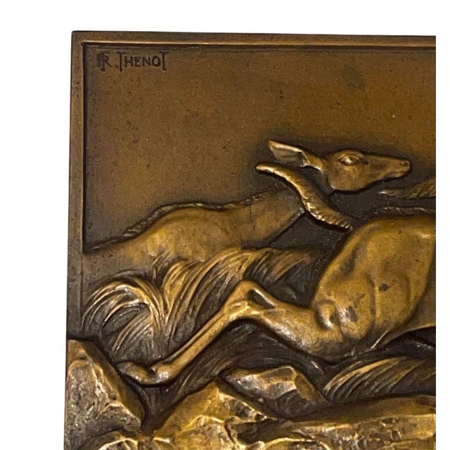 Striking pair of French Art Deco bronze plaques on stand by Thenot, depicting dynamic antelope scenes rendered in deep,...