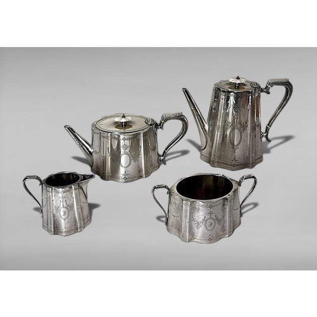 A classic English silver-plated tea and coffee service comprising four pieces. Each piece features an elegant shaped oval...