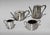 A classic English silver-plated tea and coffee service comprising four pieces. Each piece features an elegant shaped oval...