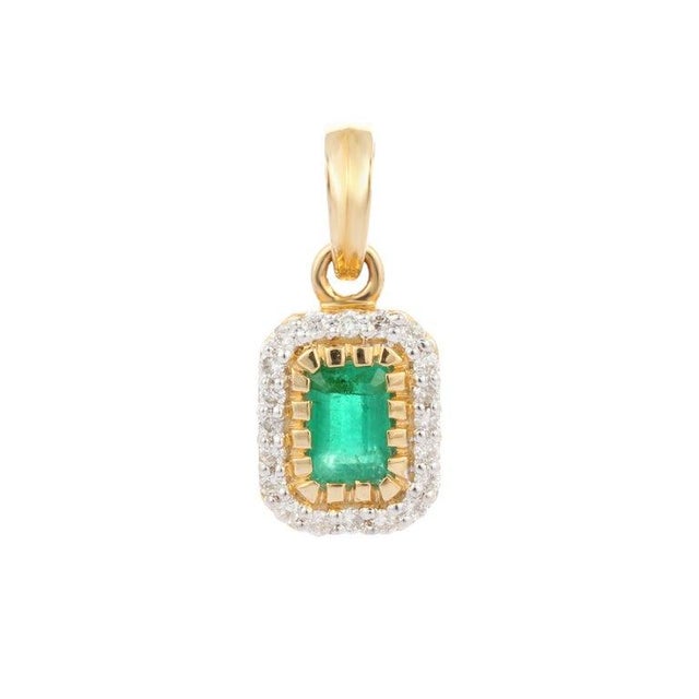 Emerald pendant in 14K Gold. It has a octagon cut emerald studded with diamonds that completes your look with a decent...