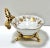 A beautiful vintage porcelain vanity dish set in an ornate gilt metal ormolu stand. The delicate gold leaf pattern and...