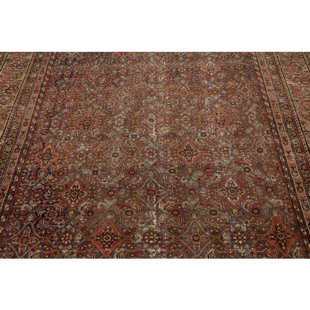 Beautiful antique Malayer hand-knotted wool rug with a blue color field. This Persian rug has rust accents in a gorgeous...