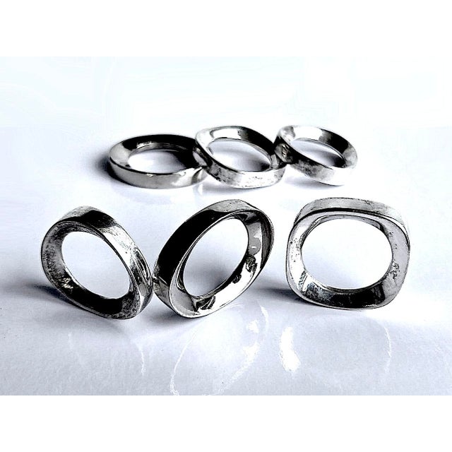 Offered is a set of 6 silver-plate napkin rings in the style of Elsa Peretti for Tiffany. They are unmarked, and include 3...