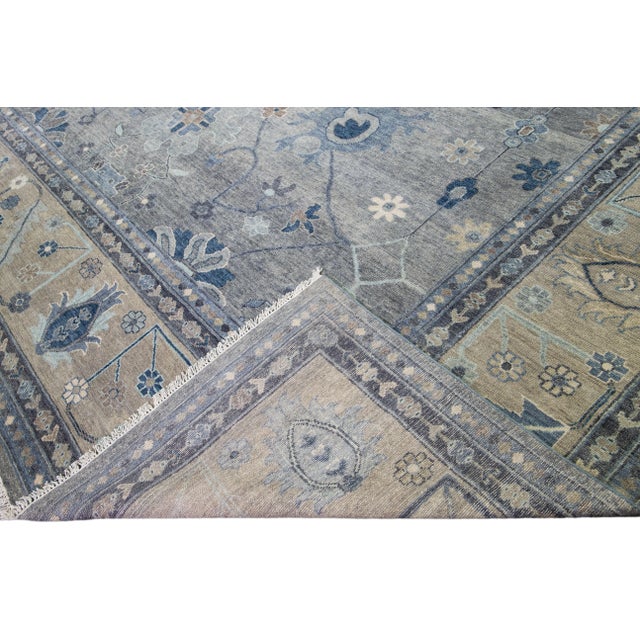 Beautiful modern Oversize Oushak hand-knotted wool rug with a gray field. This Oushak rug has a beige designed frame and...
