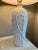 Elegant Hollywood Regency, white, ceramic, faux bamboo, embossed table lamp with a pleaded, white shade. The bamboo stalks...