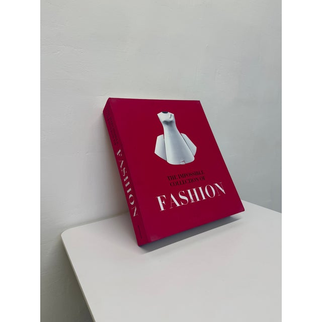 In this limited edition, Ultimate Collection format linen clamshell and handmade oversized fashion coffee table book,...