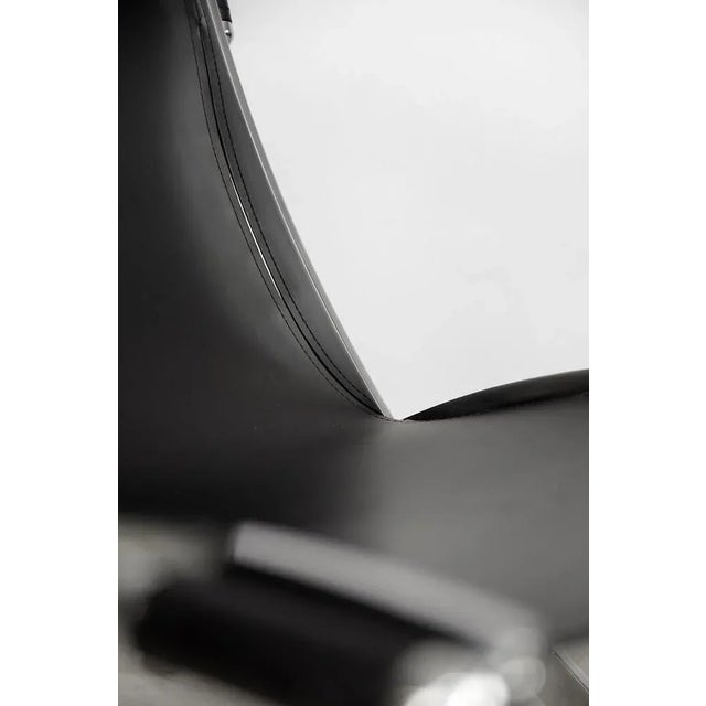 This heavy and solid yet elegant chair was manufactured in Italy during the 1980s. The chair features a chrome-plated...