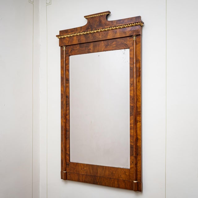 Rectangular console mirror with a slightly projecting pediment top. The frame is veneered in walnut. The upper section is...
