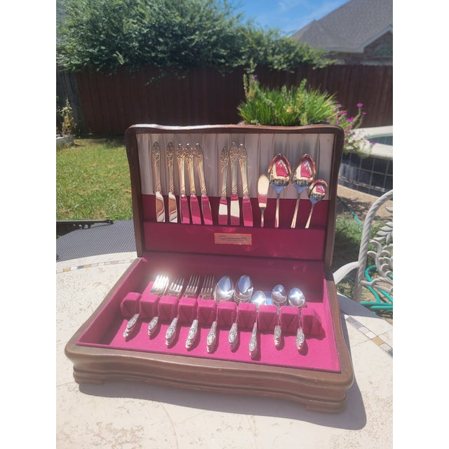 This is a beautifully preserved Community (Oneida Ltd.) silverplate flatware 52 piece set, presented in its original...