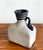 A bold and sculptural studio pottery vessel, this bottle-form vase features a raw, sand-textured stoneware body with a...