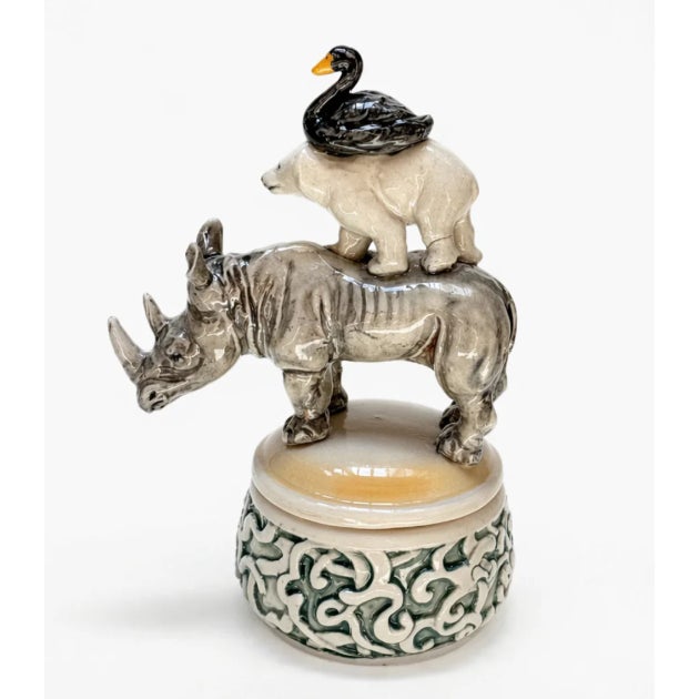 Lidded Container with Triple Handle of Rhino, Bear, and Duck transforms a simple porcelain vessel into a playful...