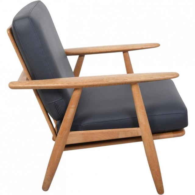 Hans wegner ge240 cigar chair with a frame of oak and new cushions upholstered with black bizon leather. The chair is from...