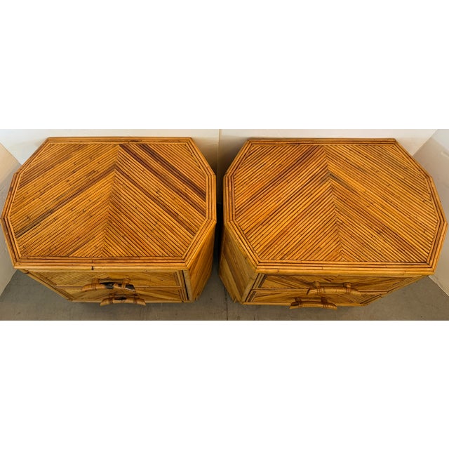 Pair of 1970s Coastal style chevron pencil reed (or split reed) bamboo nightstands. Covered entirely in tightly placed...