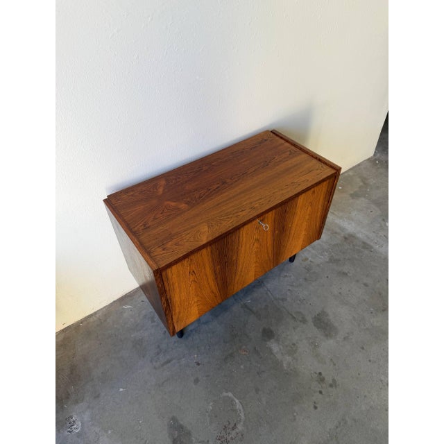 Exceptional vintage Danish Mid-Century Modern cabinet crafted in richly grained rosewood by PS System Danish Furniture,...