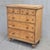 A charming late 19th century English pine faux bois painted birds eye maple chest of drawers with decorative stringing and...