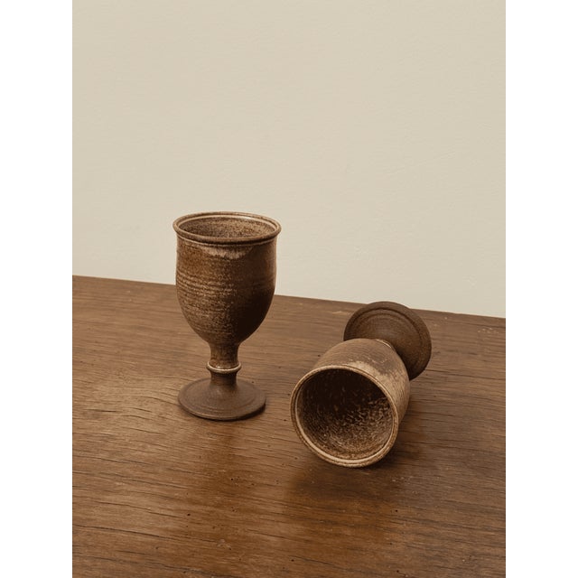 Stonewear goblets. Each piece is signed on the bottom with an impressed potter’s seal and additional mark, indicating the...