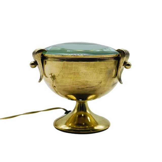 Characteristic 1950s brass goblet table lamp. Circular section stand resting on slightly flared foot, beveled glass lens...