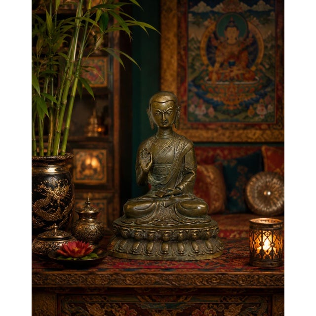 An antique Tibetan cast bronze figure depicting the revered Tibetan Buddhist scholar and saint, Je Tsongkhapa (1357–1419),...