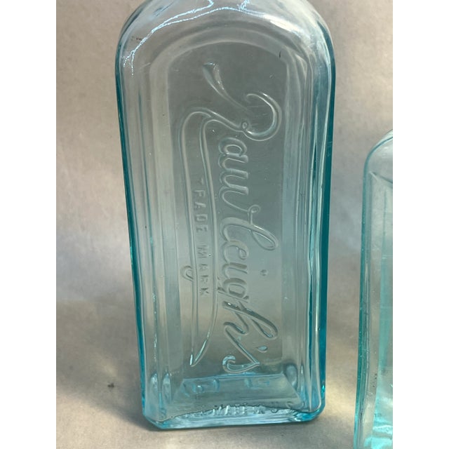 Four antique apothecary bottles in various colors and sizes all in excellent condition. Showing advertisements. Excellent...