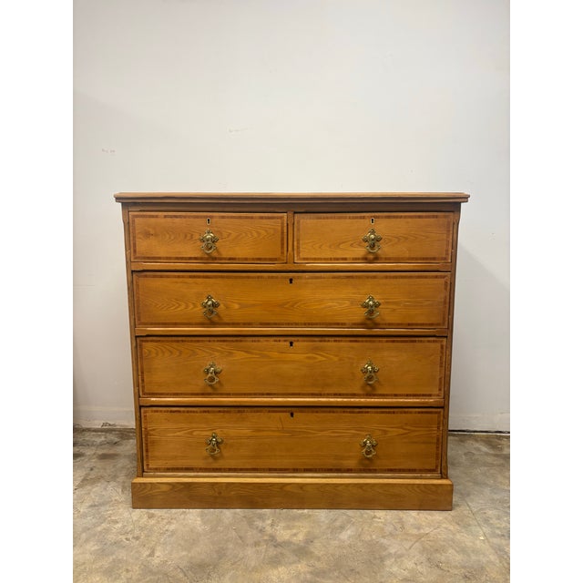 A beautiful 19th century English ash chest of drawers, showcasing exceptional craftsmanship and timeless appeal. The ash...