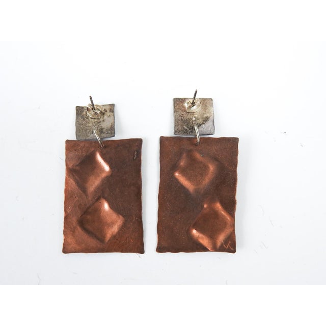 Circa 1990's artist studio made patinated copper and sterling silver earrings. Formed and hammpered copper with hammered...