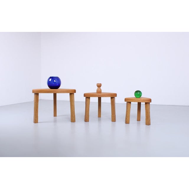 A set of three oak nesting tables, inspired by the spirit of Charlotte Perriand and Pierre Jeanneret. Robust appearance...