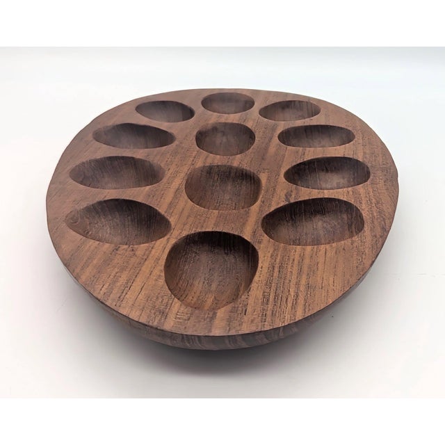 Offered is a carved Teak wood egg-shaped deviled egg platter made in the 1970s. There are carve out spaces for 12 deviled...