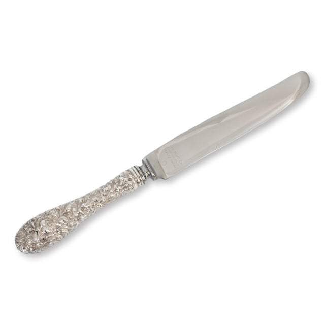 Set of seven antique Kirk Stieff Rose dinner knives with sterling silver handles and stainless steel blades. Introduced in...
